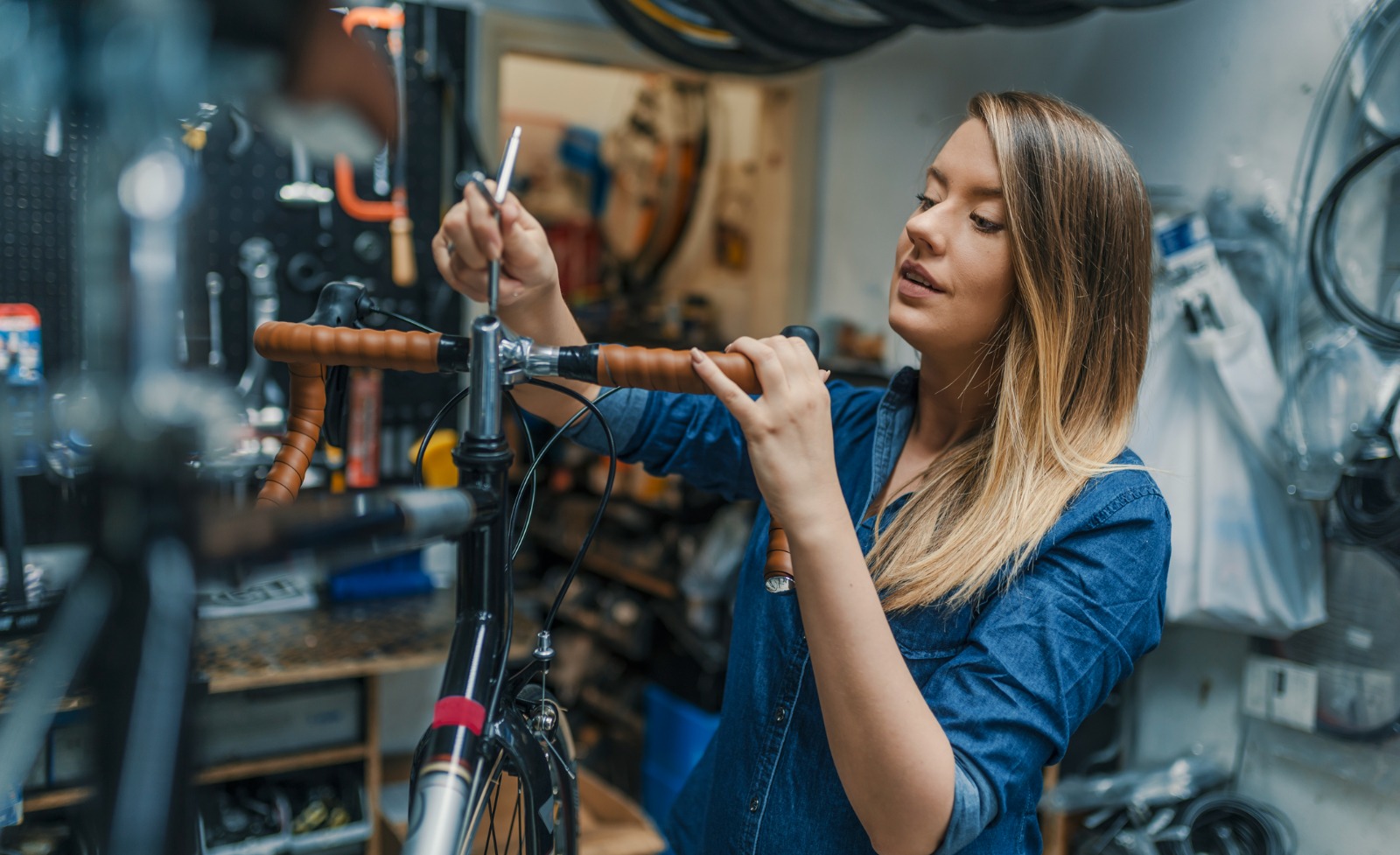 A bicycle shop employee repairing a bicycle.