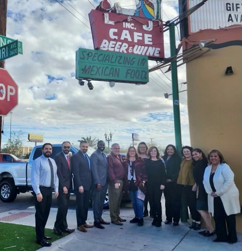 Small business owners standing under the L and J cafe sign in El Paso, Texas