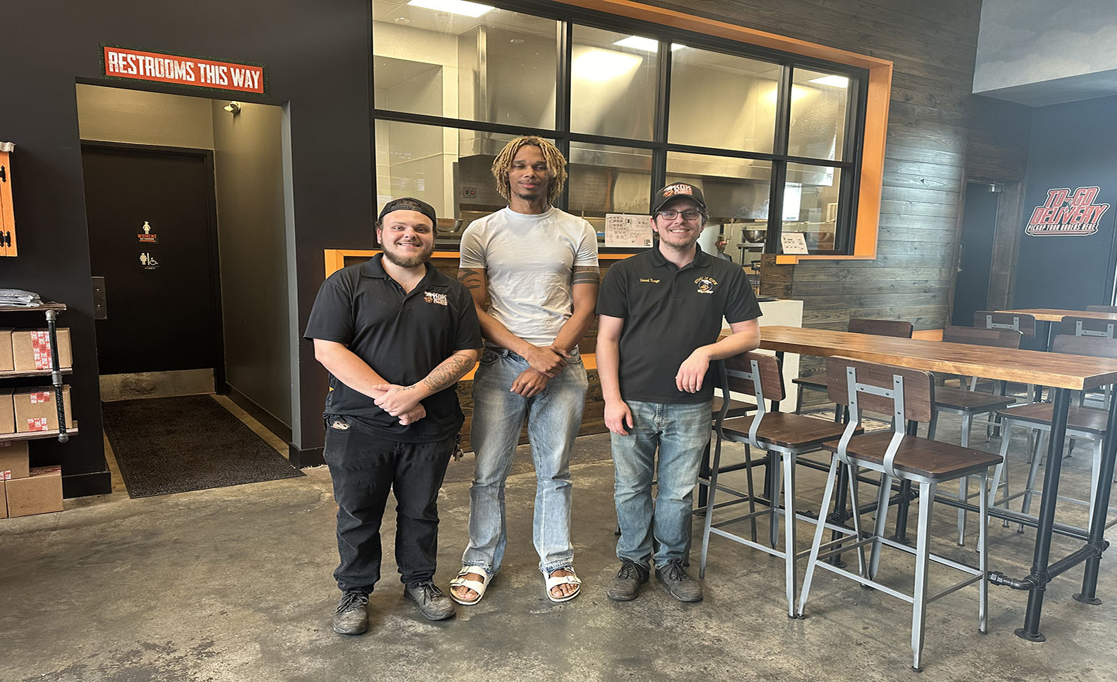 KOK Wings & Things owner Tre'jan Vison (center) with employee (left) and general manager (right).