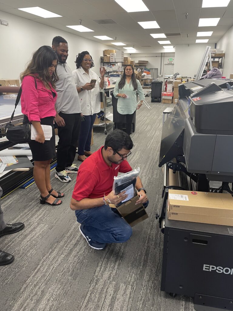 Office of Advocacy employees Janis Reyes, Jason Bussey, and M.B. Humphrey during a site visit to AlphaGraphics in Delaware 2024.