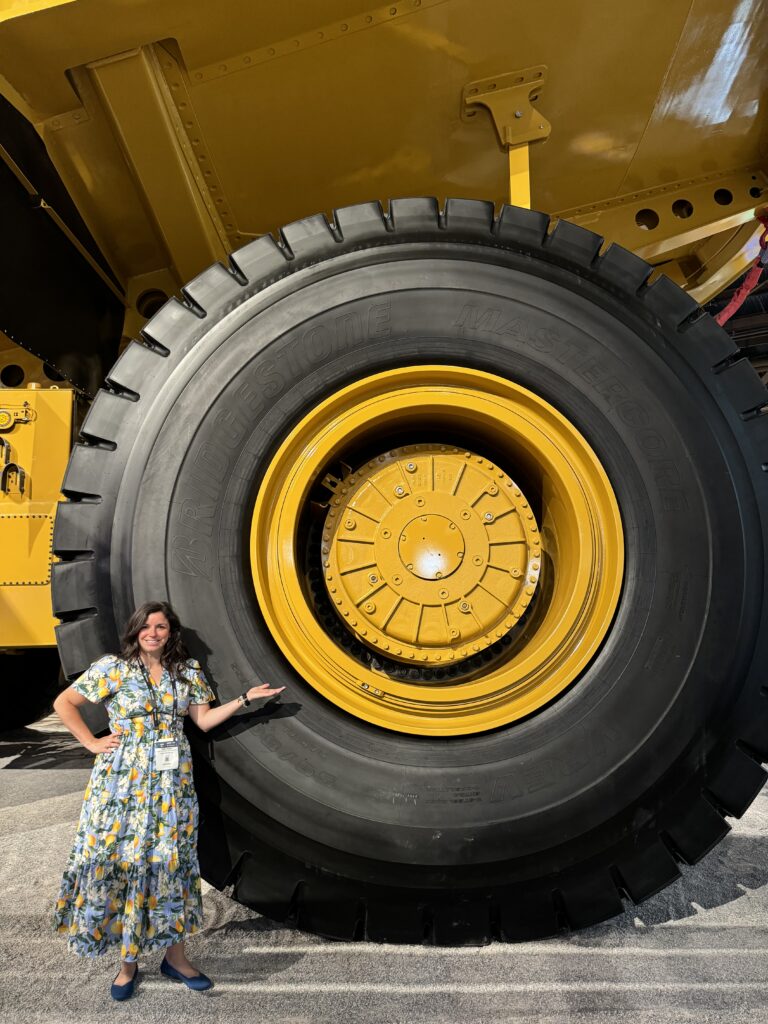 Assistant Chief Counsel Emily Jones posing next to a large tire.