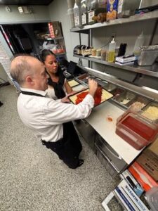 Regional Affairs Director, Tom Rossomando, making a pizza from scratch at Santucci's on Franchise Day.